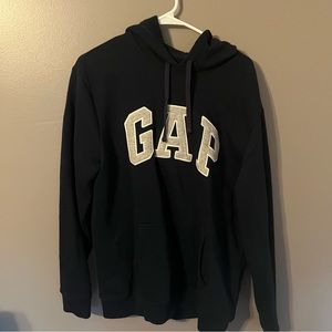 This is a navy blue gap hoodie with a grey color logo that hits true to size
